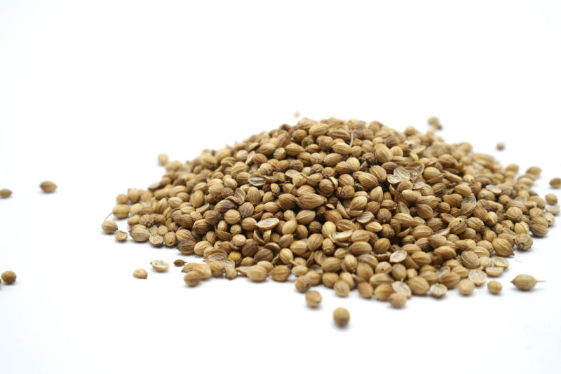 a pile of coriander on a white backdrop