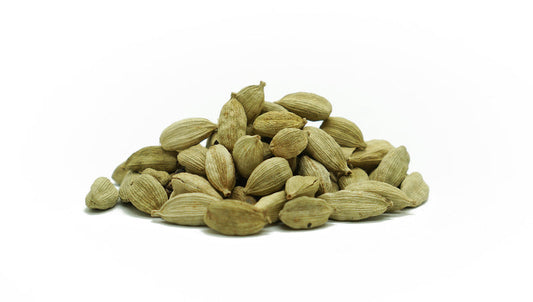 a pile of cardamom pods on a white background