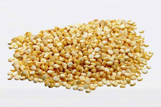 A pile of dry quinoa grains on a white background